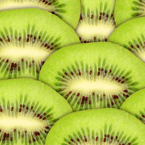 Abstract green background with raw kiwi slices
