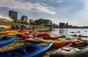 Kayakers in front of the Dayton skyline